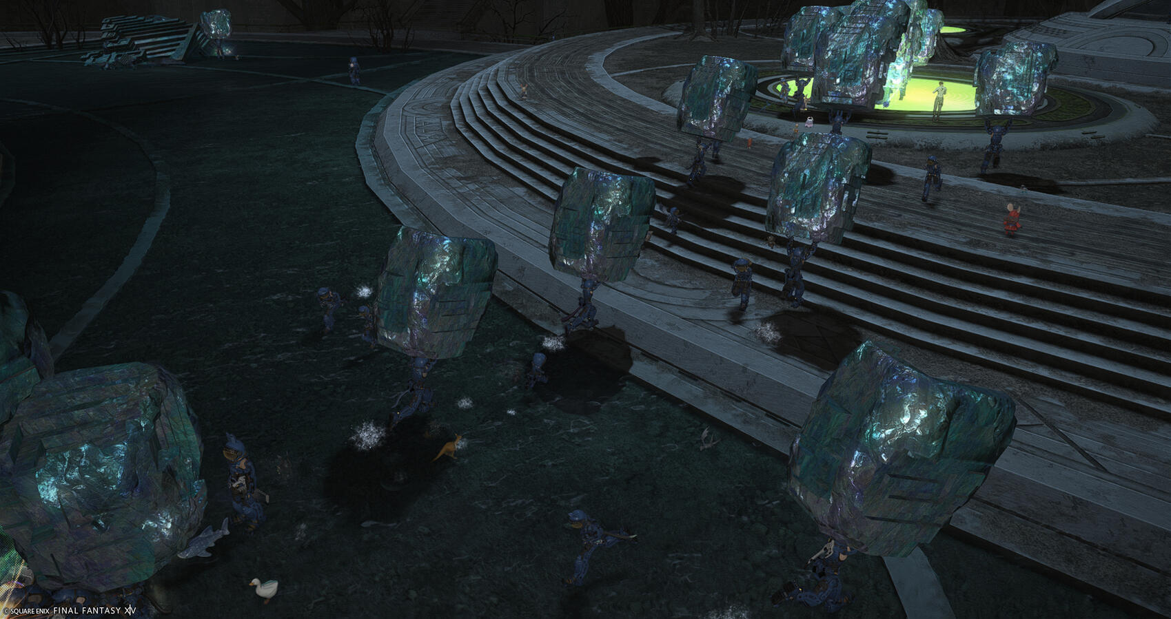 Warriors of Light dressed in blue Power-suits trickle in a line towards a glowing green circle at the base of the tower, each carrying a massive chunk of stone above their heads as they go.