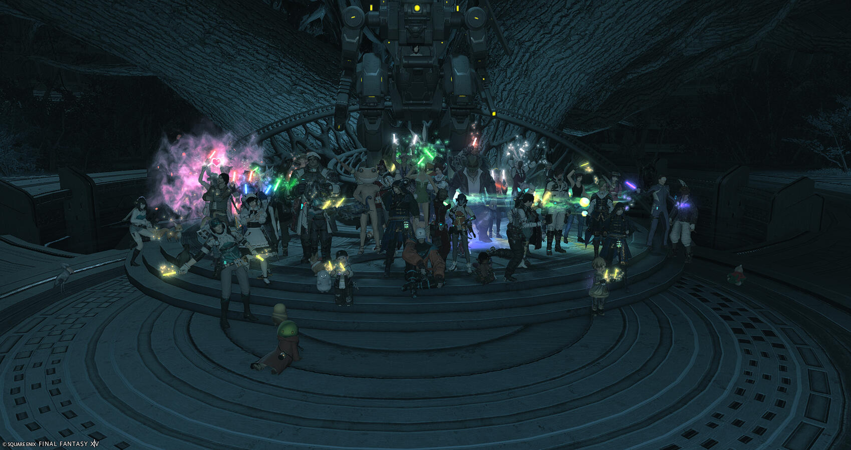 A group of Warriors of Light on Excalibur gather for a group photo in front of the seemingly dormant Grandma Laurel tree that rests at the heart of Auxesia.